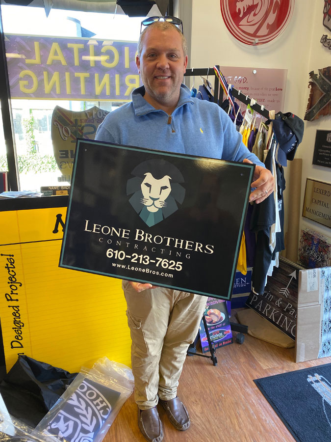 Leone Brothers Sign Held by Customer