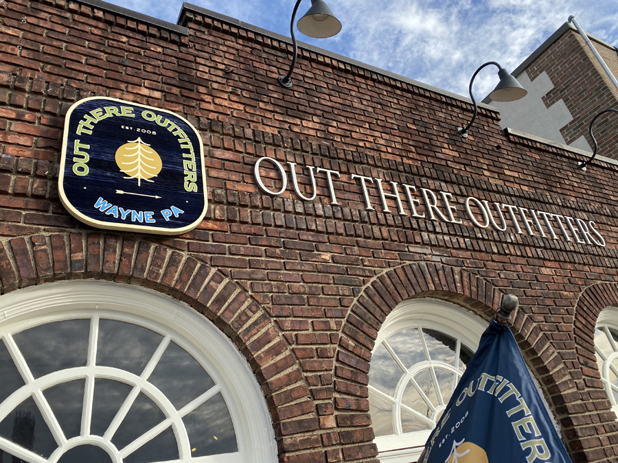 Out There Outfitters Sign on Building Side View
