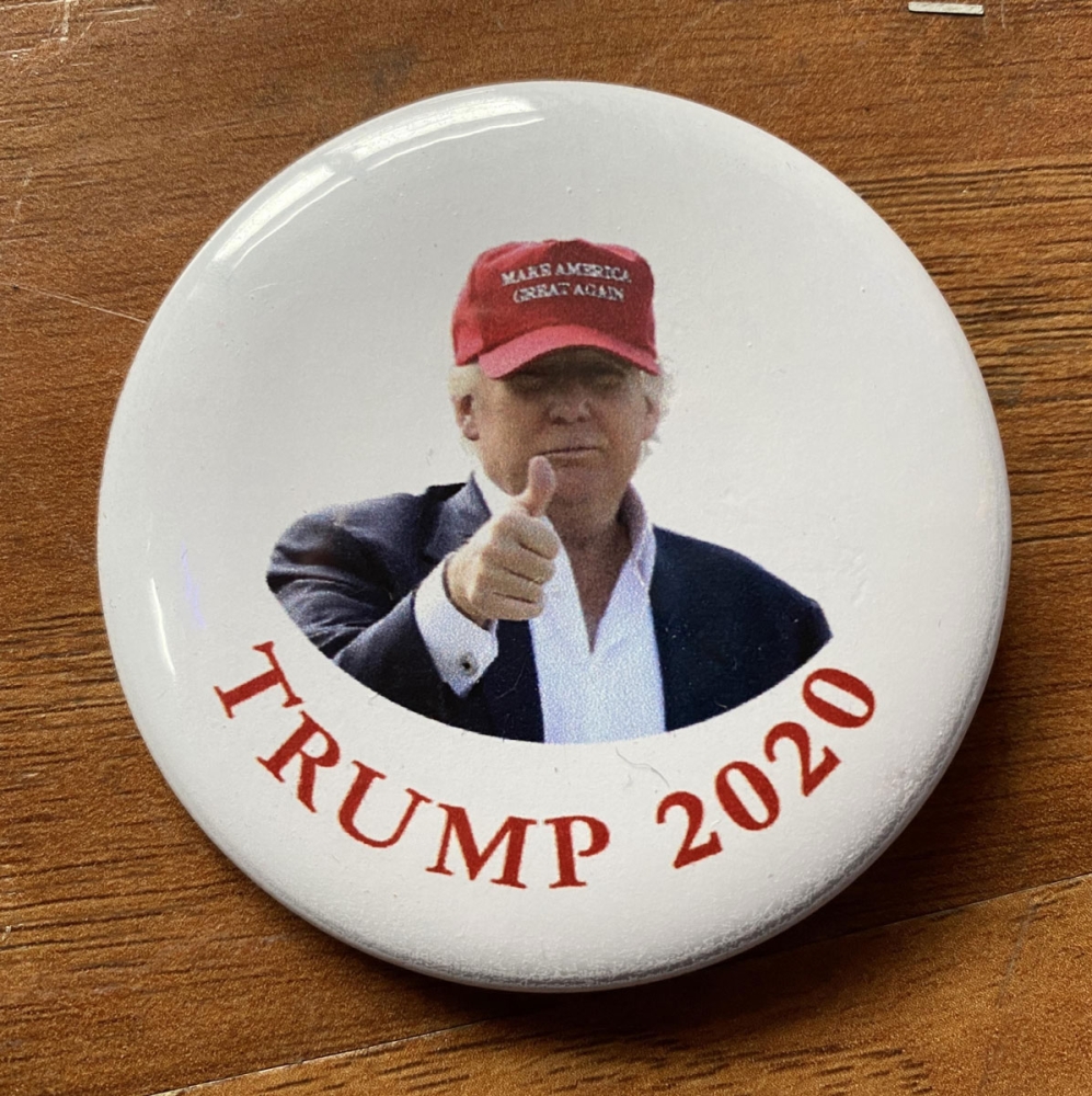 Trump Wearing a Hat Button closeup